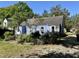 Charming blue house featuring a well-maintained exterior and a serene backyard setting at 1012 Virgie St, Durham, NC 27705