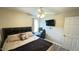 Comfortable bedroom with light walls, workstation, and modern fan with overhead lighting at 1021 Forest Glen Dr, Raleigh, NC 27603