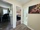 Hallway view with doorways to two bedrooms, a bathroom, and decor with wood-look flooring at 1021 Forest Glen Dr, Raleigh, NC 27603