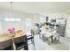 Open kitchen and dining area with stainless appliances, an island, and a wooden dining set at 1021 Forest Glen Dr, Raleigh, NC 27603