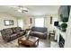 Cozy living room featuring comfortable leather sofas, a ceiling fan, and a decorative fireplace at 1021 Forest Glen Dr, Raleigh, NC 27603