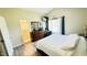 Bright main bedroom featuring a large dresser, workstation, and ensuite bathroom access at 1021 Forest Glen Dr, Raleigh, NC 27603
