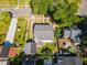 Aerial view of the property featuring a well-manicured lawn, a swimming pool, and a detached garage at 104 N Green St, Selma, NC 27576