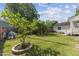 Lush backyard featuring a swing set and mature landscaping, offering a perfect outdoor retreat at 104 N Green St, Selma, NC 27576