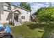 This large backyard features a home with white siding, a swing set, and a small slide at 104 N Green St, Selma, NC 27576