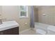Bathroom featuring a bathtub, shower, vanity, and toilet, offering modern convenience at 104 N Green St, Selma, NC 27576