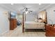 This bedroom features a four-poster bed, wood floors, a ceiling fan and large TV at 104 N Green St, Selma, NC 27576