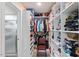 Walk-in closet with built-in shelves and ample storage for clothing and accessories at 104 N Green St, Selma, NC 27576