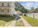 Two-story home boasts a detached garage with driveway and a well-maintained yard at 104 N Green St, Selma, NC 27576