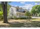 Two-story house with charming front porch, mature trees, and a well-maintained yard at 104 N Green St, Selma, NC 27576