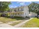 Two-story home with a detached garage, well-maintained lawn, and a charming front porch at 104 N Green St, Selma, NC 27576