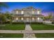 Charming two-story home boasts a welcoming front porch, lush lawn, and manicured landscaping at 104 N Green St, Selma, NC 27576