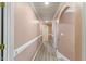 Hallway with neutral-colored walls and flooring, providing access to various rooms in the home at 104 N Green St, Selma, NC 27576