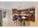 Modern kitchen featuring granite countertops, wooden cabinets, stainless steel appliances, and tile flooring at 104 N Green St, Selma, NC 27576