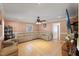Spacious living room with large leather sectional sofa, ceiling fan, and tile flooring at 104 N Green St, Selma, NC 27576