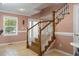 Elegant staircase with wooden railing and decorative trim, adding charm to the home's entrance at 104 N Green St, Selma, NC 27576