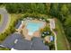 Aerial view of the community pool featuring lounge areas, tables and umbrellas surrounded by lush trees at 108 Boone St, Chapel Hill, NC 27516