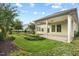 Spacious backyard featuring a covered patio, manicured lawn, and meticulously maintained landscaping at 108 Boone St, Chapel Hill, NC 27516