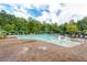 Community pool with in-pool seating, lounge chairs, and covered cabanas amid a brick patio at 108 Boone St, Chapel Hill, NC 27516