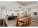 Open dining area with chandelier, kitchen with island, stainless appliances, and living area with fireplace at 108 Boone St, Chapel Hill, NC 27516