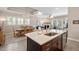 Open layout with island kitchen featuring granite countertops, bar seating, dining area, and living area beyond at 108 Boone St, Chapel Hill, NC 27516
