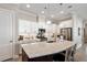 Bright kitchen featuring white cabinets, stainless steel appliances, granite countertops, and island with seating at 108 Boone St, Chapel Hill, NC 27516