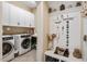 Laundry Room displaying a full size washer and dryer and storage cabinets at 108 Boone St, Chapel Hill, NC 27516