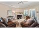 Comfortable living room featuring neutral décor, a fireplace, and large windows for ample natural light at 108 Boone St, Chapel Hill, NC 27516