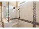 Spacious walk-in shower featuring beautiful tile accents, a rainfall shower head, and built in bench at 108 Boone St, Chapel Hill, NC 27516