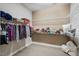 Spacious walk-in closet showcasing lots of shoe racks, shelves for clothing and folded items at 108 Boone St, Chapel Hill, NC 27516