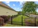 Well-maintained yard with manicured lawn, mature trees, and black iron fence, offering privacy and curb appeal at 108 Boone St, Chapel Hill, NC 27516