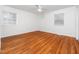 Bright bedroom with hardwood floors, a ceiling fan, and windows offering ample natural light at 1103 Brucemont Dr, Garner, NC 27529
