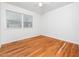 Sun-filled bedroom has gleaming hardwood floors, ceiling fan, and a large window for natural light at 1103 Brucemont Dr, Garner, NC 27529