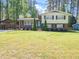 Charming two-story home with brick facade and a well-manicured lawn at 1103 Brucemont Dr, Garner, NC 27529