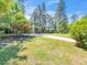 Charming home with a well-manicured front yard, mature trees, and a long driveway at 1103 Brucemont Dr, Garner, NC 27529