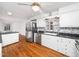 Bright kitchen with stainless steel appliances and white cabinets at 1103 Brucemont Dr, Garner, NC 27529