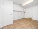 Well-lit laundry room with tiled floor, storage cabinets, and utility connections at 1103 Brucemont Dr, Garner, NC 27529