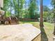 Stamped concrete patio enhances a tranquil backyard setting with a lawn, deck and mature trees at 1103 Brucemont Dr, Garner, NC 27529