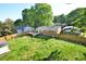 A large backyard with a deck and fenced-in yard; trees and nearby houses are visible at 114 Short E St, Hillsborough, NC 27278