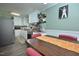 Bright kitchen featuring white cabinetry, stainless steel appliances, and a view of the dining area with seating at 114 Short E St, Hillsborough, NC 27278
