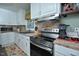 Updated kitchen with stainless steel appliances, ample counter space, and a breakfast bar, perfect for cooking and entertaining at 114 Short E St, Hillsborough, NC 27278