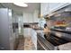 Modern kitchen with stainless steel appliances, white cabinets, and granite countertops providing a stylish cooking space at 114 Short E St, Hillsborough, NC 27278