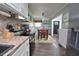 Modern kitchen with stainless steel appliances, granite countertops, and a breakfast bar for easy dining at 114 Short E St, Hillsborough, NC 27278