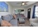 Inviting living room with plush gray sofa, a ceiling fan, and wood-look floors, perfect for relaxation at 114 Short E St, Hillsborough, NC 27278