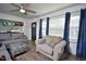 Comfortable living room with lots of natural light, neutral tones, modern ceiling fan, and view to dining room at 114 Short E St, Hillsborough, NC 27278