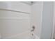 Clean white tiled shower features a built-in niche, offering a modern and functional bathing experience at 114 Short E St, Hillsborough, NC 27278