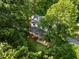 Stunning aerial view of a home surrounded by lush greenery, offering a private and tranquil setting at 1149 Highway Nc 87, Pittsboro, NC 27312