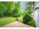 Lush backyard with mature trees and a wood deck, perfect for enjoying the outdoors at 1149 Highway Nc 87, Pittsboro, NC 27312