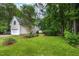 Spacious backyard with verdant lawn, landscaping, and a detached garage with ample privacy at 1149 Highway Nc 87, Pittsboro, NC 27312