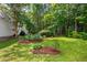 Lush backyard featuring well-manicured flower beds, perfect for outdoor relaxation and gardening enthusiasts at 1149 Highway Nc 87, Pittsboro, NC 27312